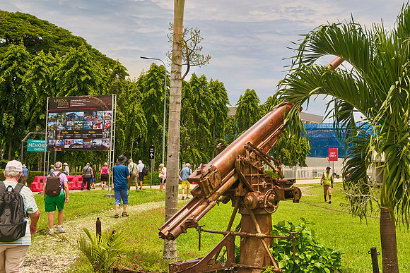 An anti-aircraft gun stands along the path to the memorial forest